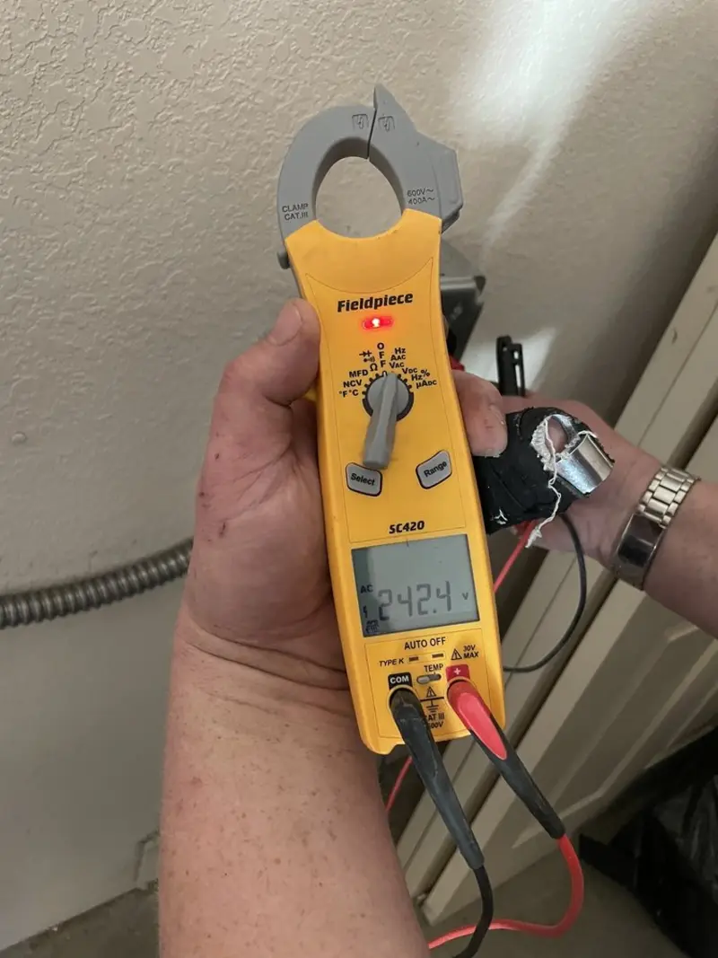 Voltage testing with clamp meter during Aluminum Wiring Replacement in Ash